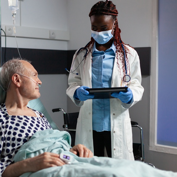 Doctor with Chirurgical mask in hospital room discussing diagnosis