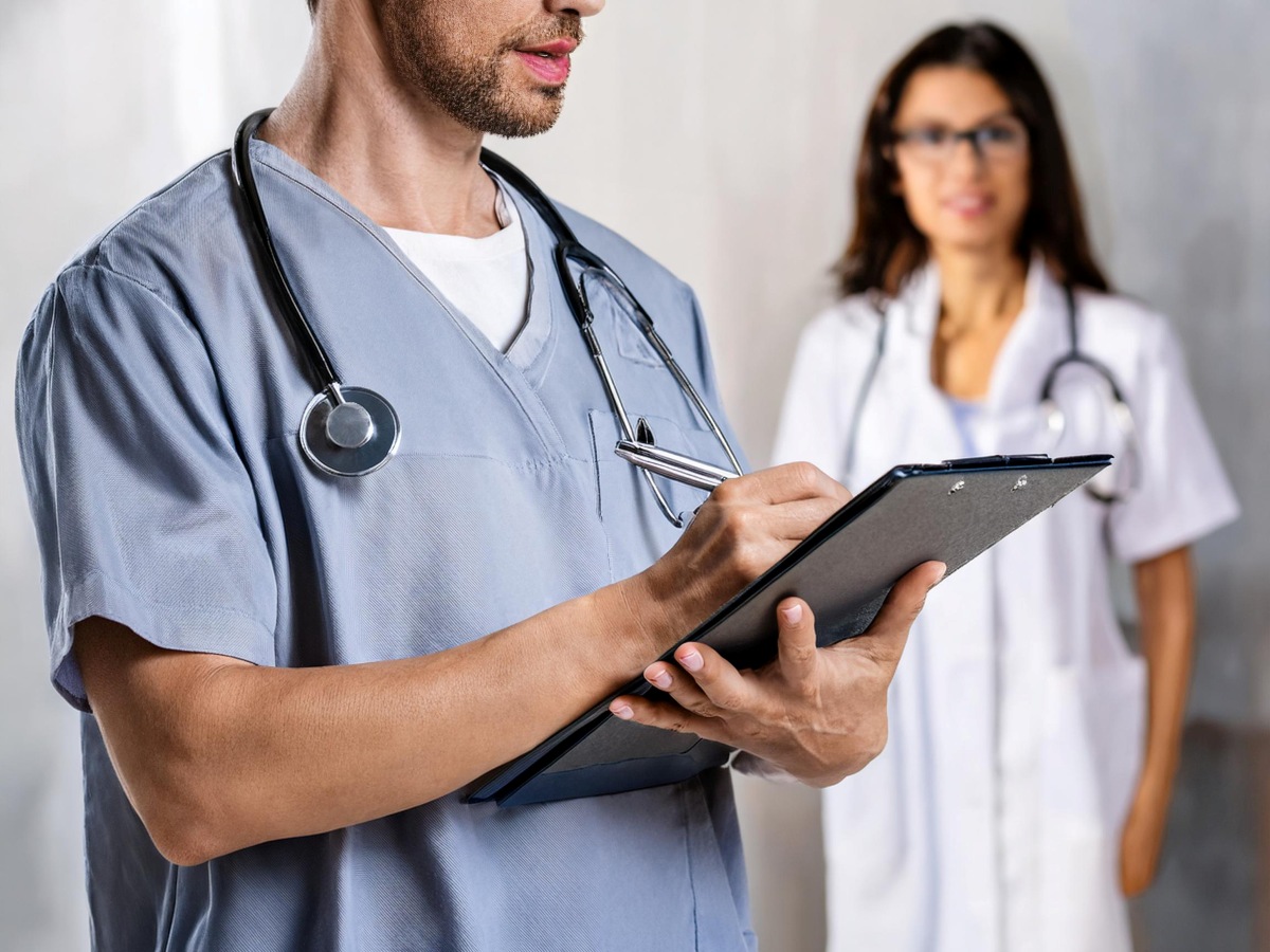 Doctor Holding Clipboard With Patient